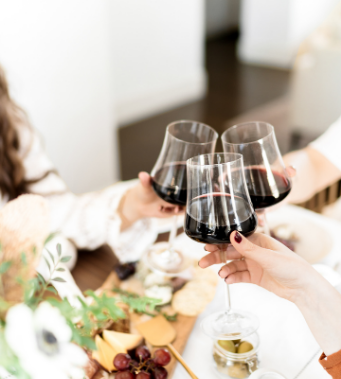 group-of-women-cheers-with-red-wine
